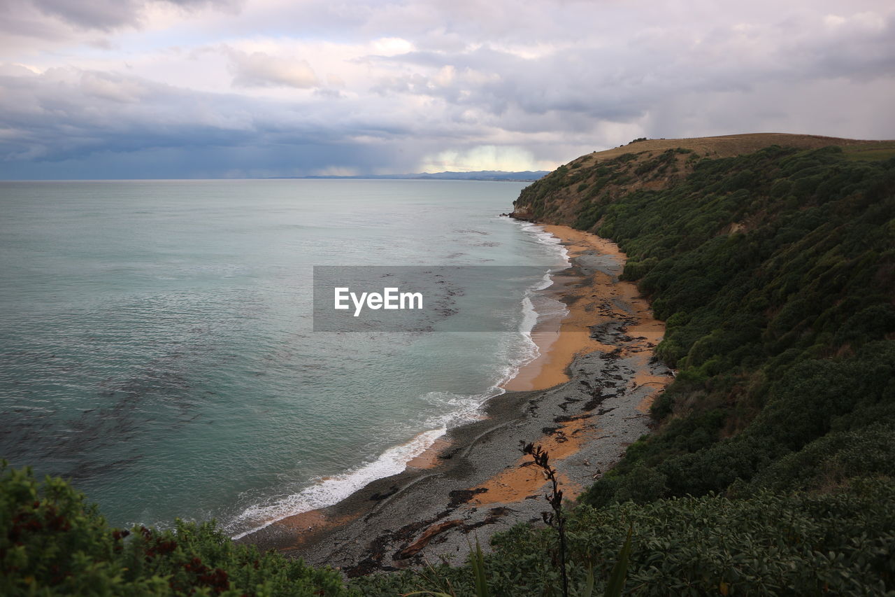 SCENIC VIEW OF SEA AND MOUNTAIN AGAINST SKY