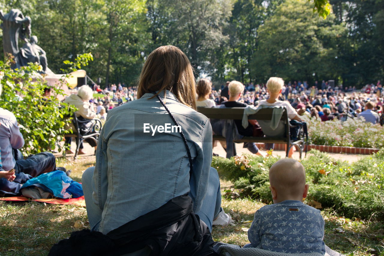Rear view of people sitting in park