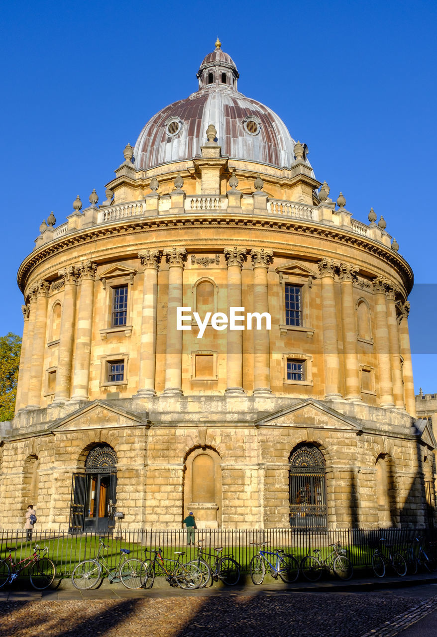 architecture, building exterior, built structure, landmark, travel destinations, dome, sky, nature, building, clear sky, ancient history, travel, history, historic site, city, the past, blue, sunny, no people, tourism, day, outdoors, facade, low angle view, plant, sunlight, place of worship