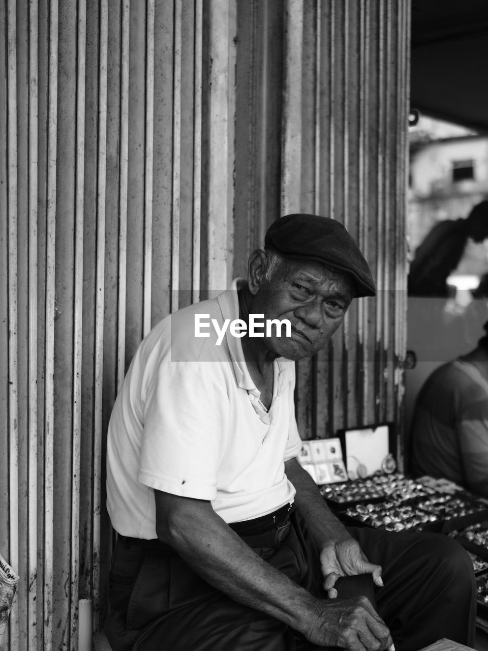 Portrait of mature man selling rings at market