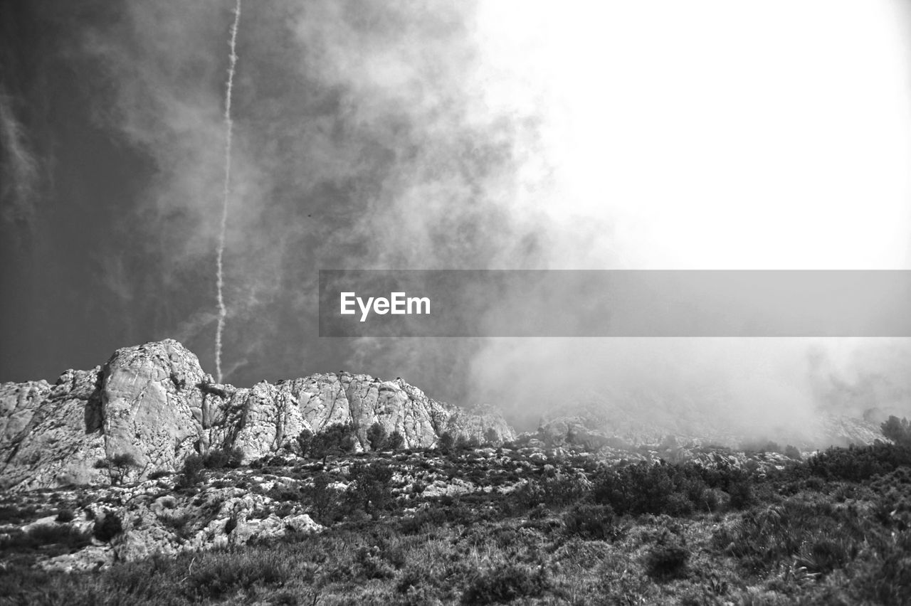 Scenic view of landscape against cloudy sky