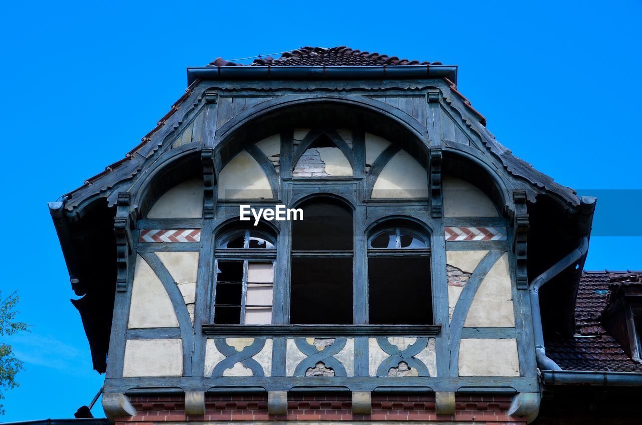 Low angle view of historical building against blue sky