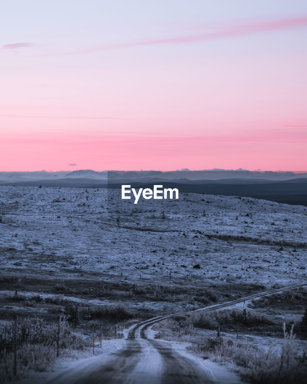 Scenic view of land against sky during sunset