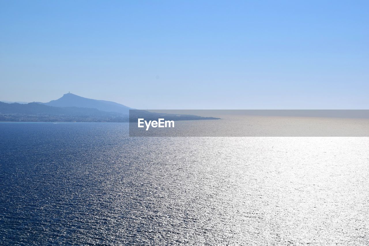 Scenic view of sea against clear blue sky