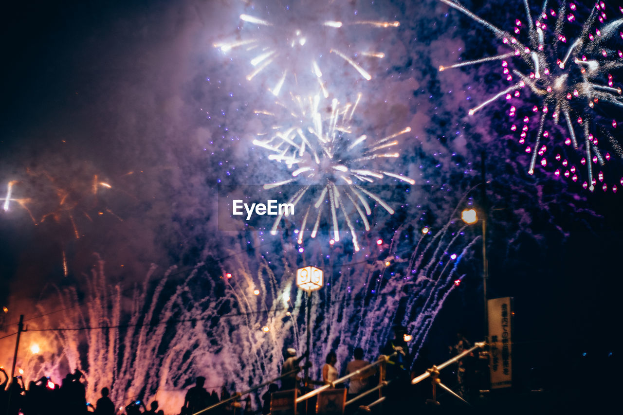 LOW ANGLE VIEW OF FIREWORK DISPLAY