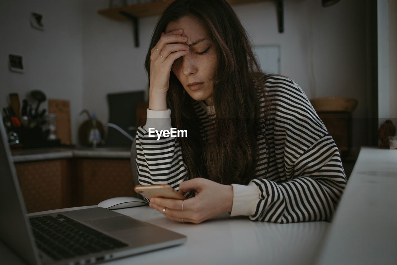 Young woman using laptop at home