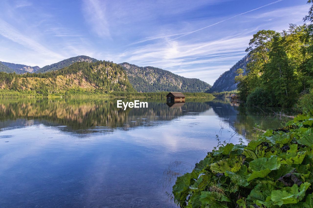 Scenic view of lake and mountains against sky