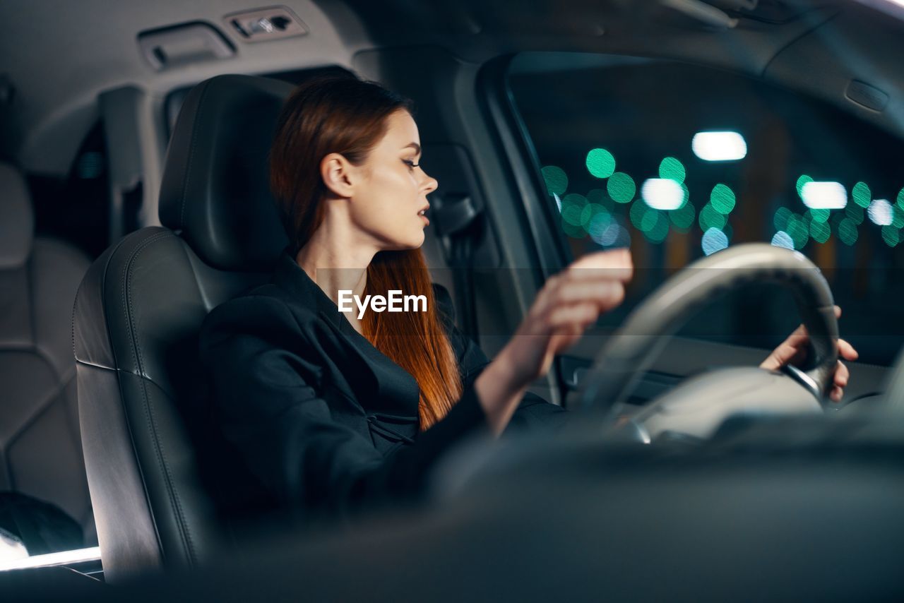 Young woman driving car