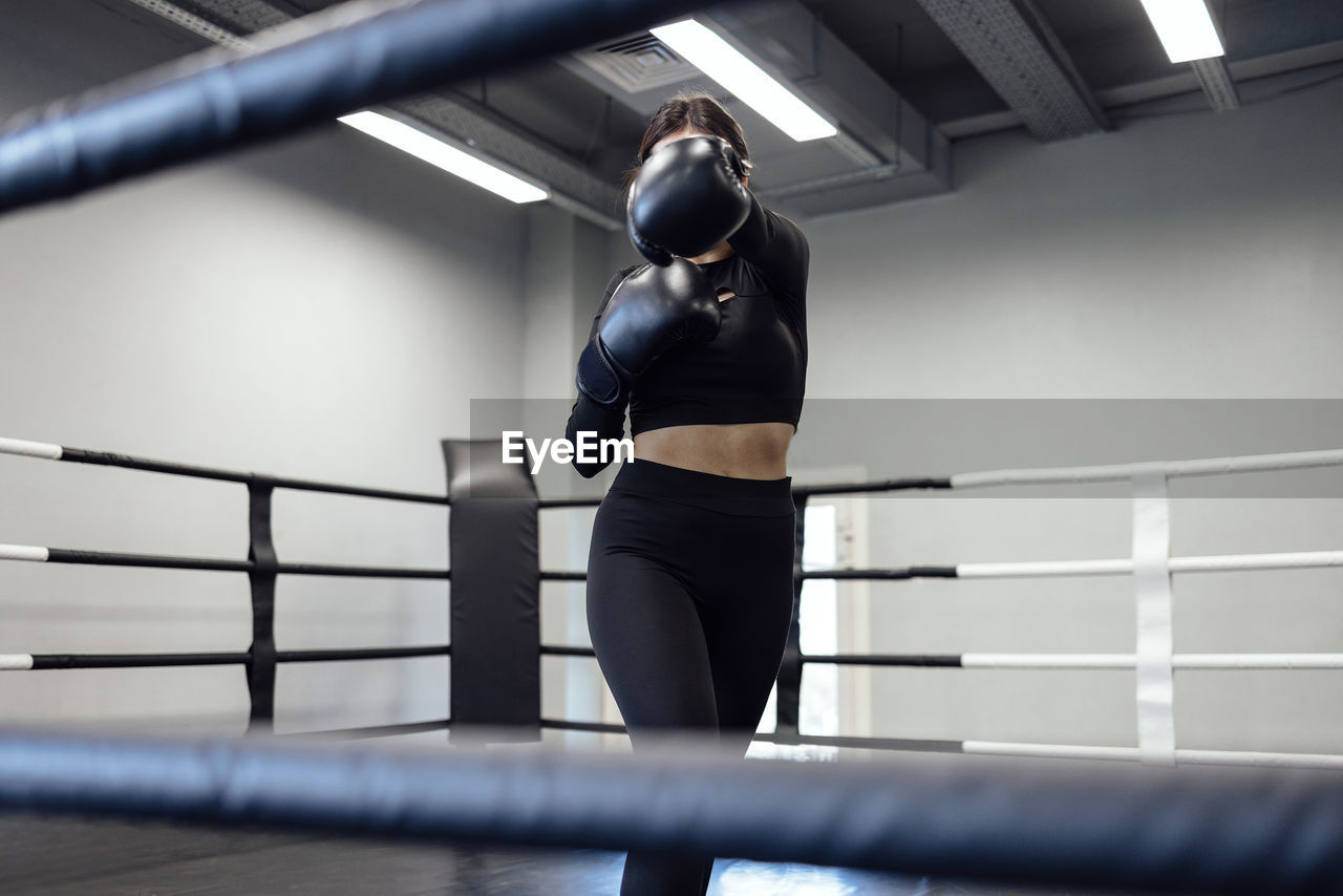 side view of young woman exercising in gym