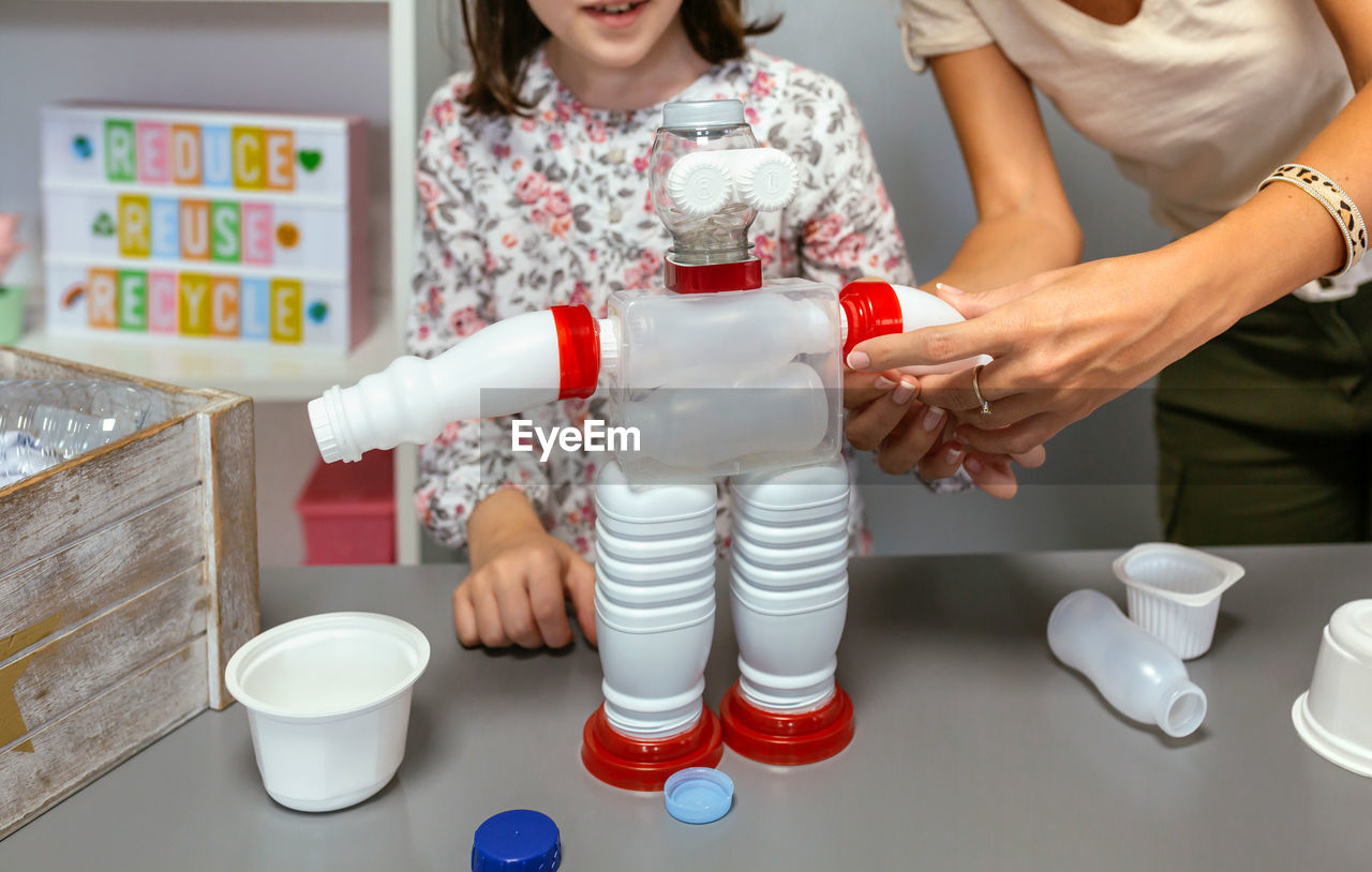 Recycled toy robot with plastic packages in ecology classroom