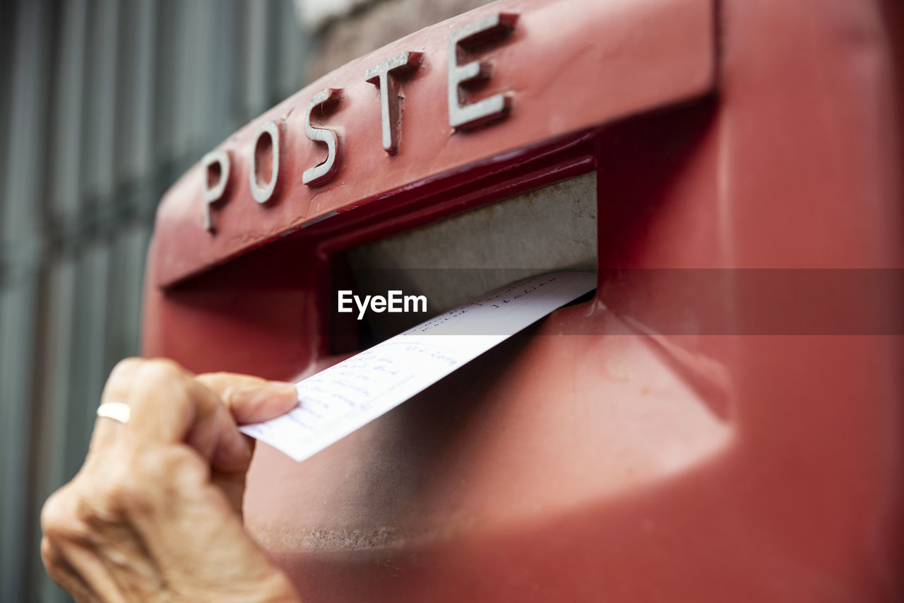 Woman dropping envelope in postbox