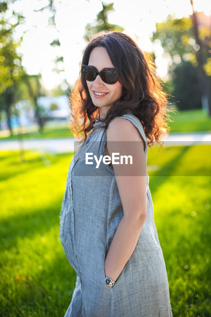 Portrait of smiling young woman wearing sunglasses