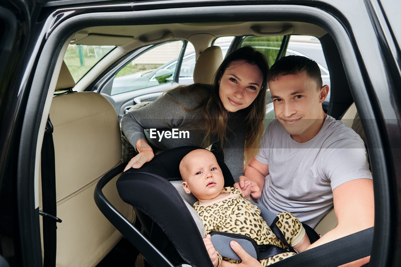 portrait of happy family in car