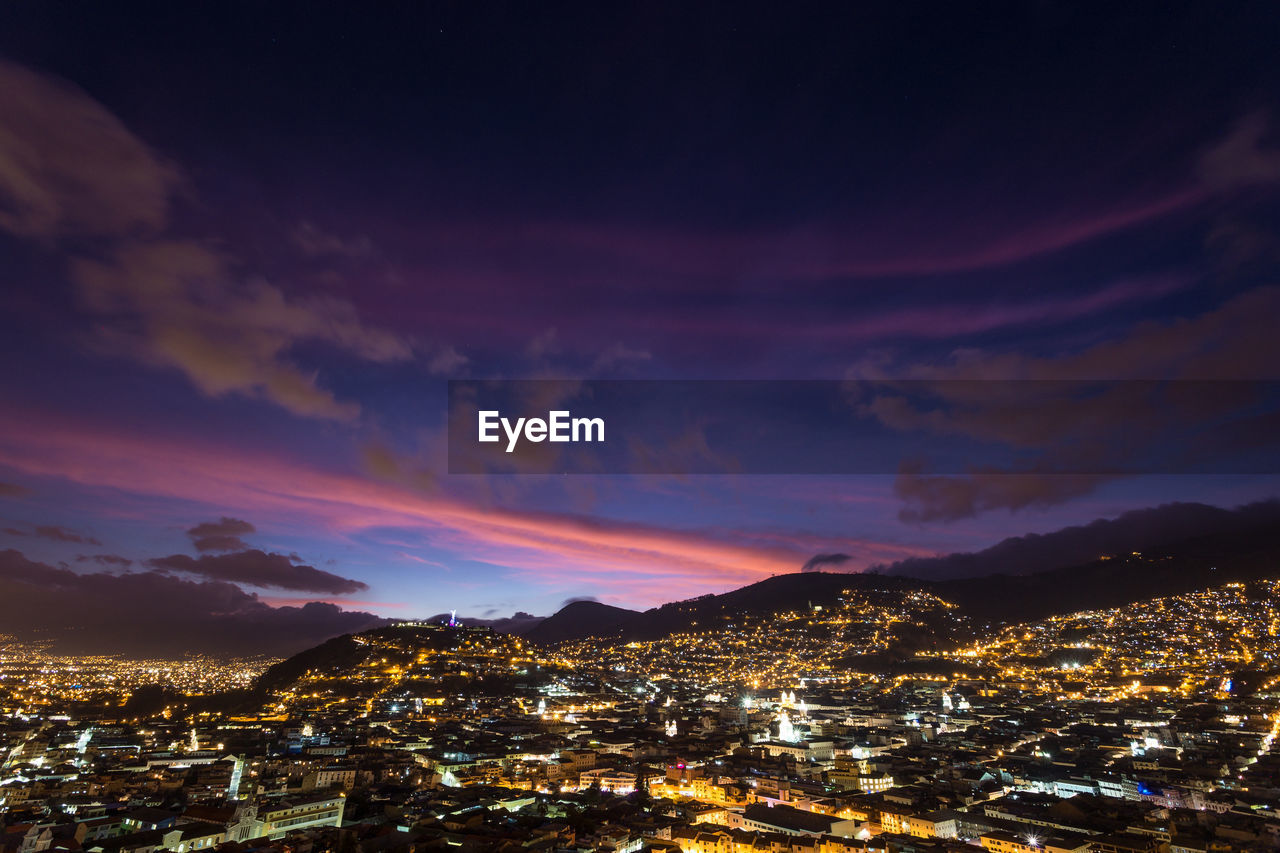 High angle view of illuminated buildings against sky during sunset