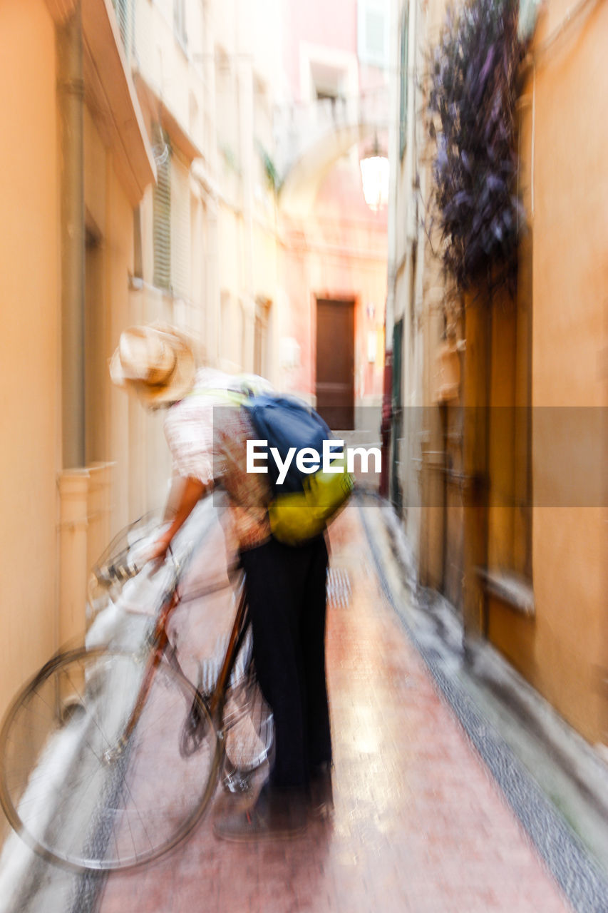 BLURRED MOTION OF WOMAN WEARING MASK IN MIRROR