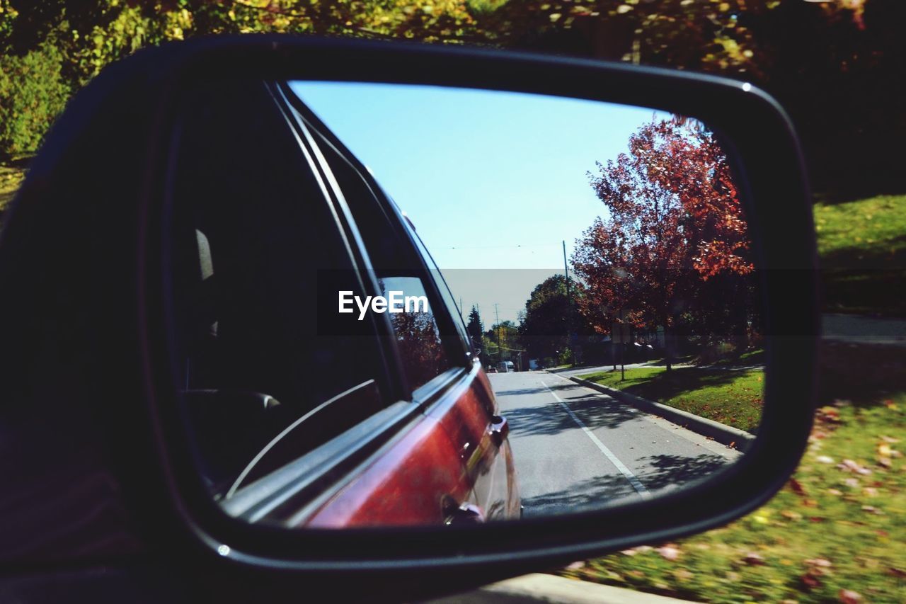 Reflection of street in rear view mirror