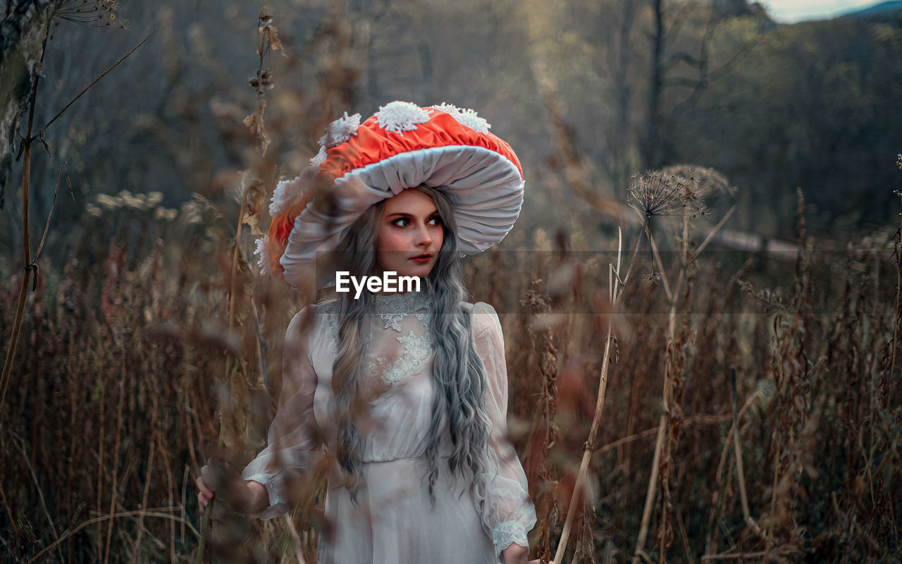 Portrait of woman standing in forest