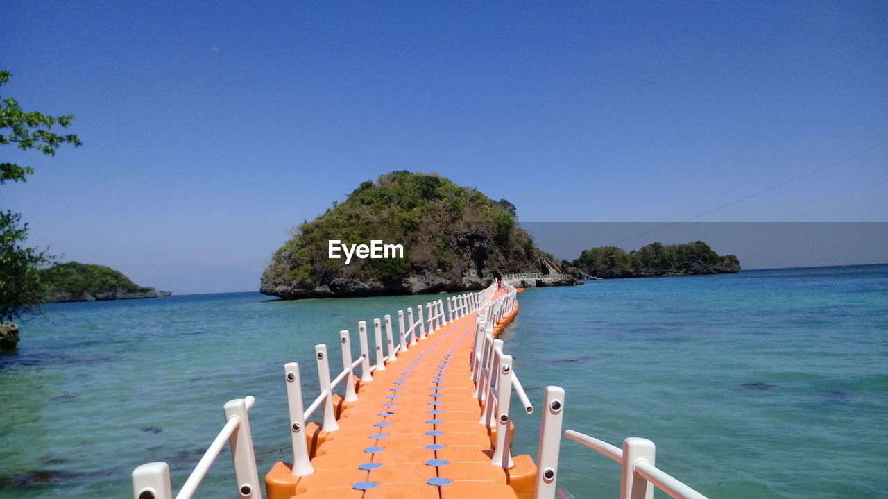 Scenic view of sea against clear blue sky