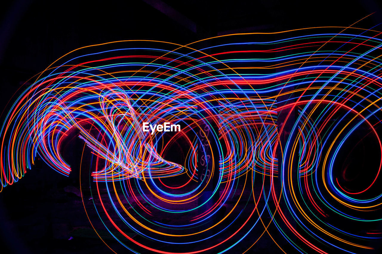 Close-up of colorful light painting glowing at night