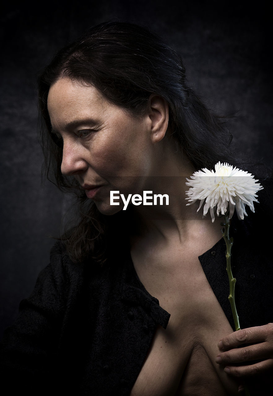 Woman in melancholic attitude with white chrysanthemum viii