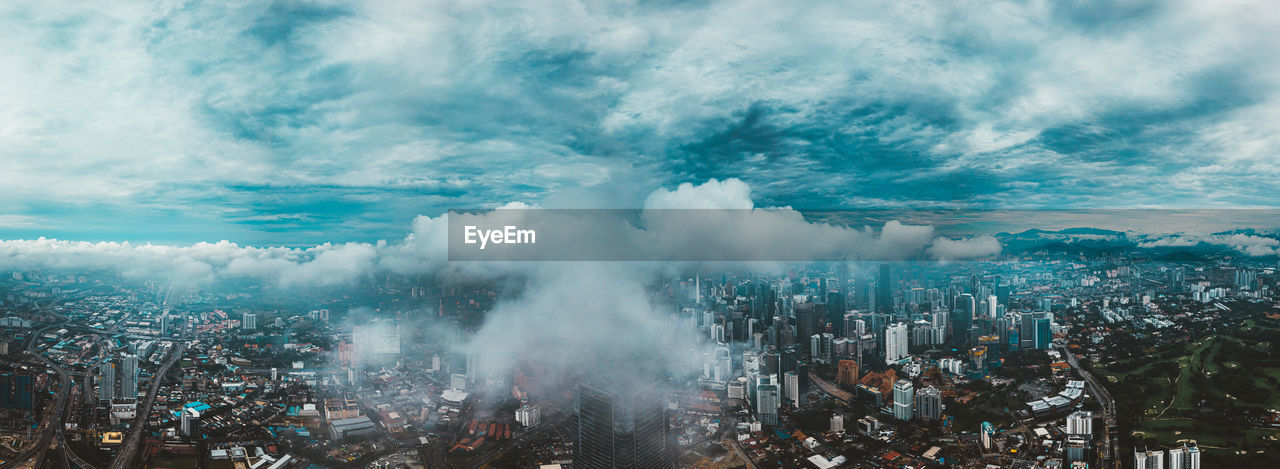 High angle view of city against cloudy sky