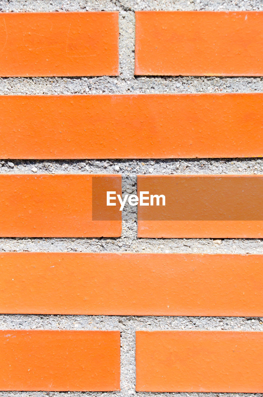 full frame, backgrounds, orange color, pattern, brick, orange, wall - building feature, architecture, built structure, brick wall, no people, textured, wall, brickwork, floor, close-up, repetition, day, brown, building exterior, outdoors, red, in a row