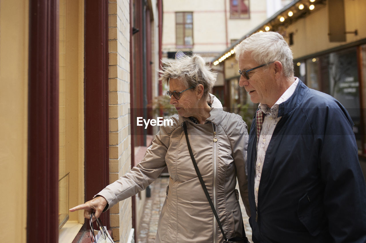 Mature couple looking at shop window