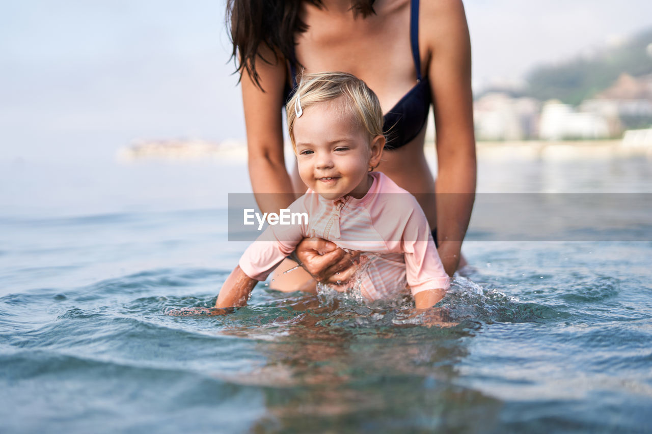 portrait of young woman swimming in lake