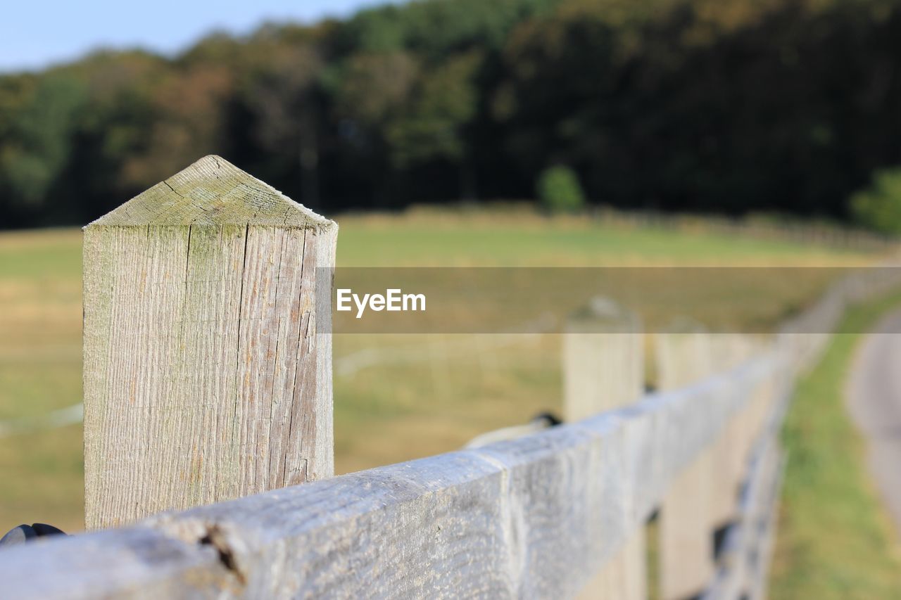 Close-up of wooden fence on field