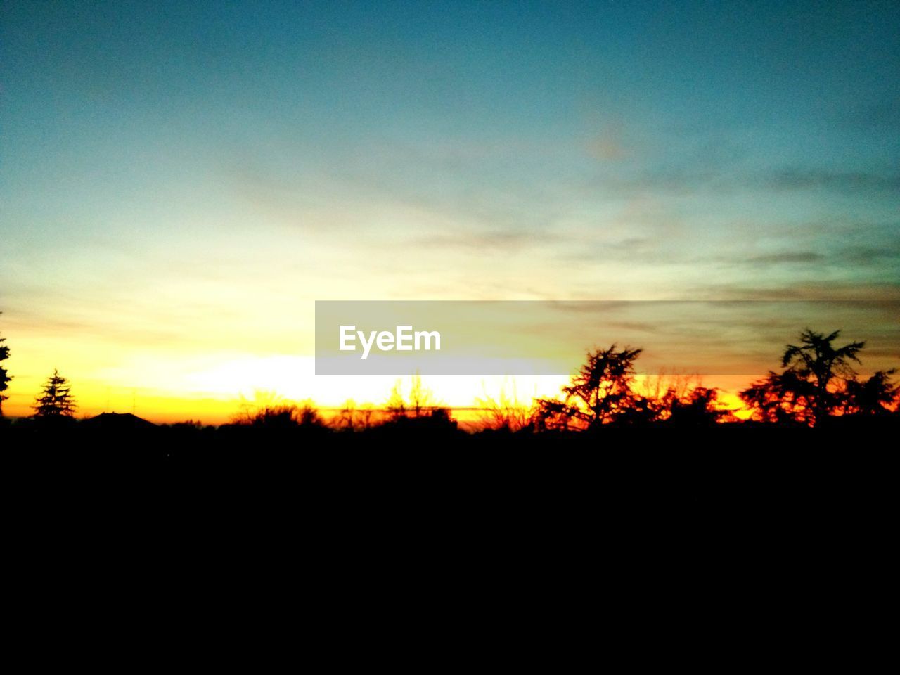 SILHOUETTE OF LANDSCAPE AT SUNSET