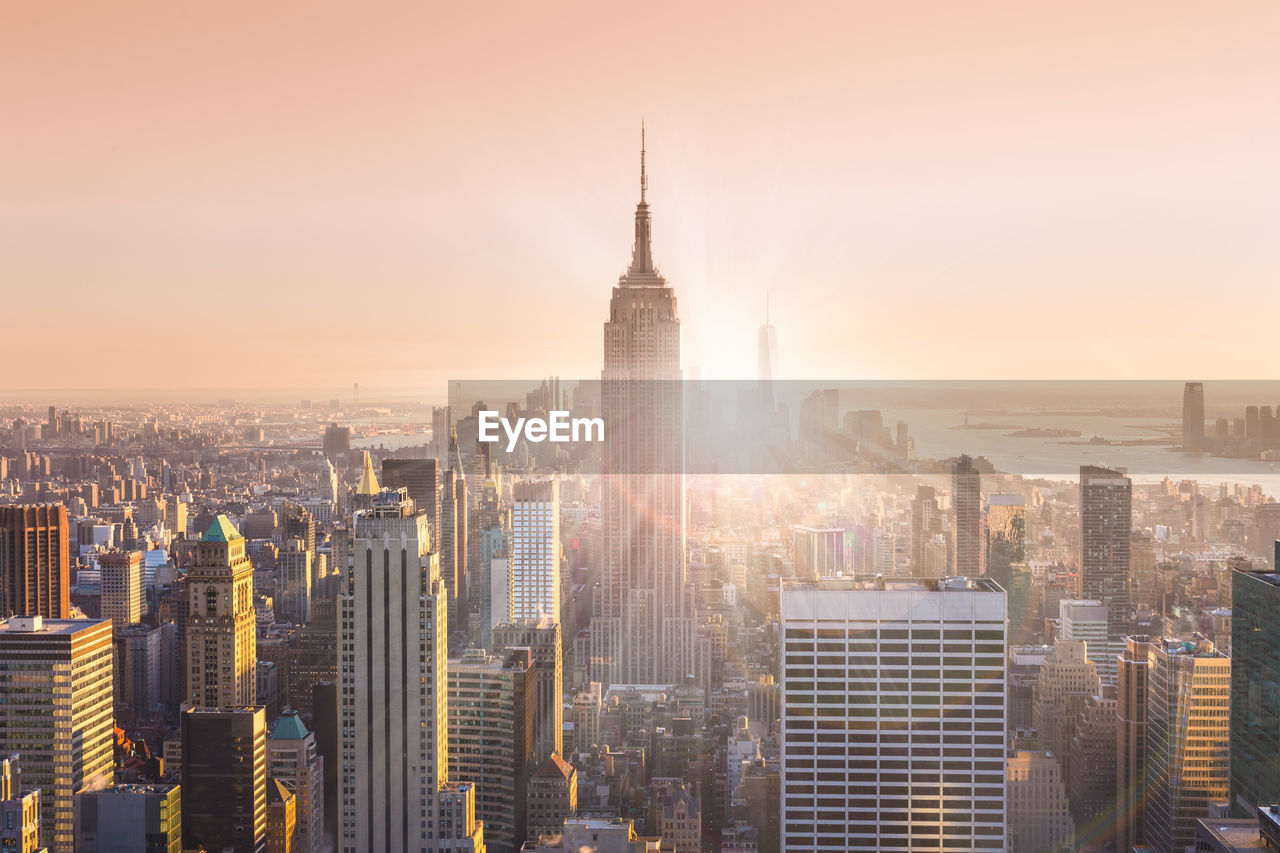 AERIAL VIEW OF BUILDINGS IN CITY AGAINST SKY