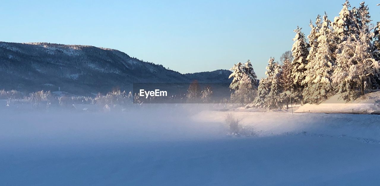 SCENIC VIEW OF SNOWCAPPED MOUNTAIN AGAINST CLEAR SKY