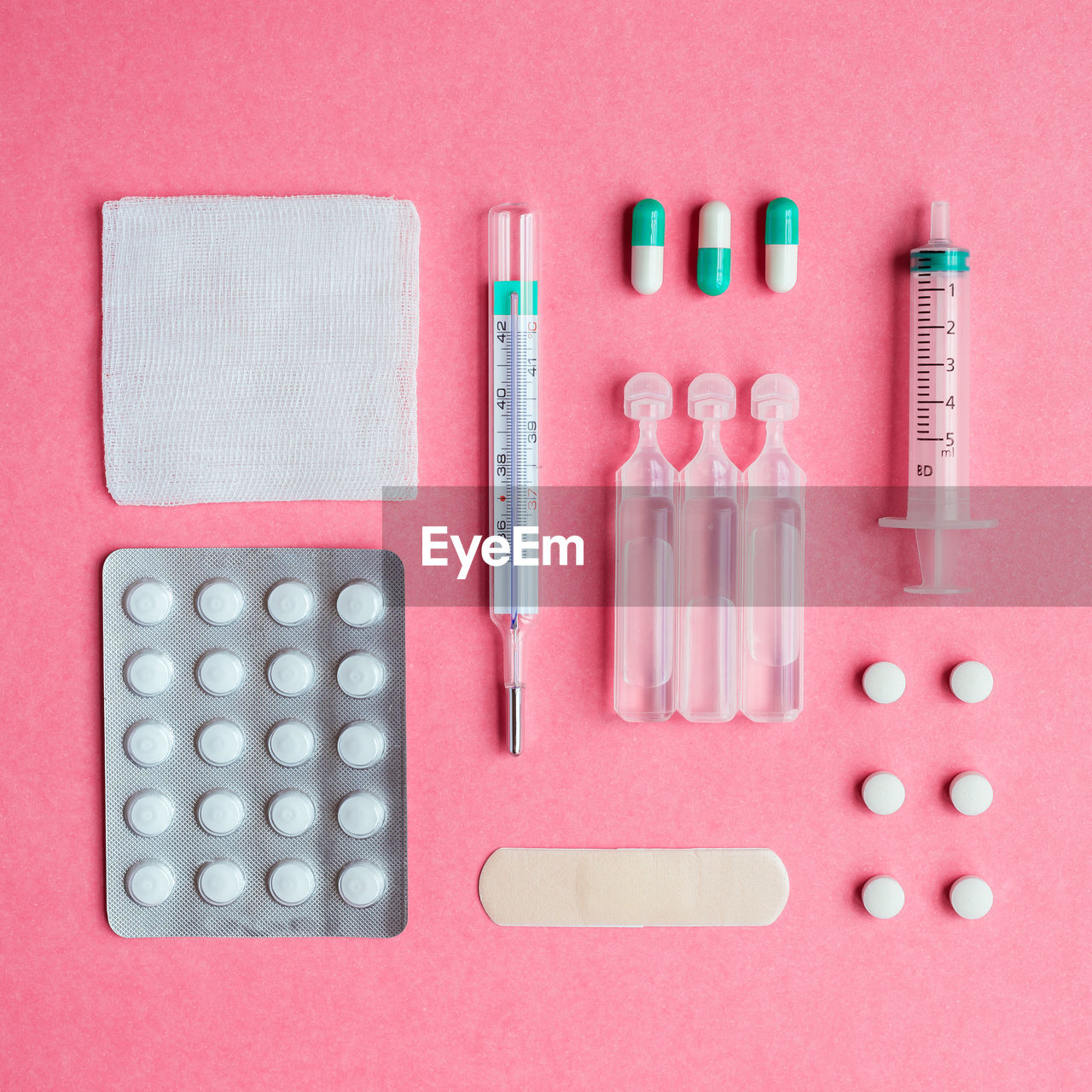 Still life of medical supplies on pink background