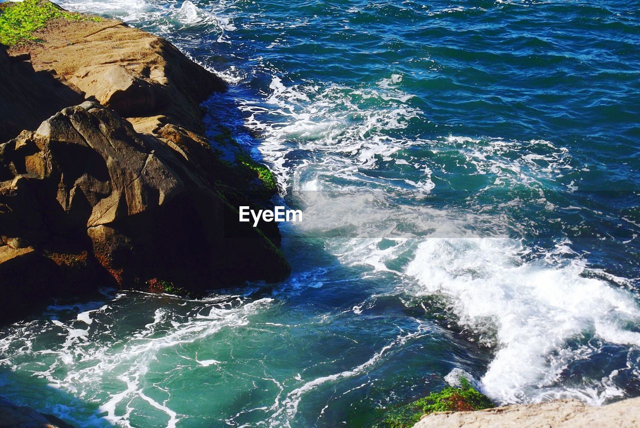 WAVES SPLASHING ON ROCKS