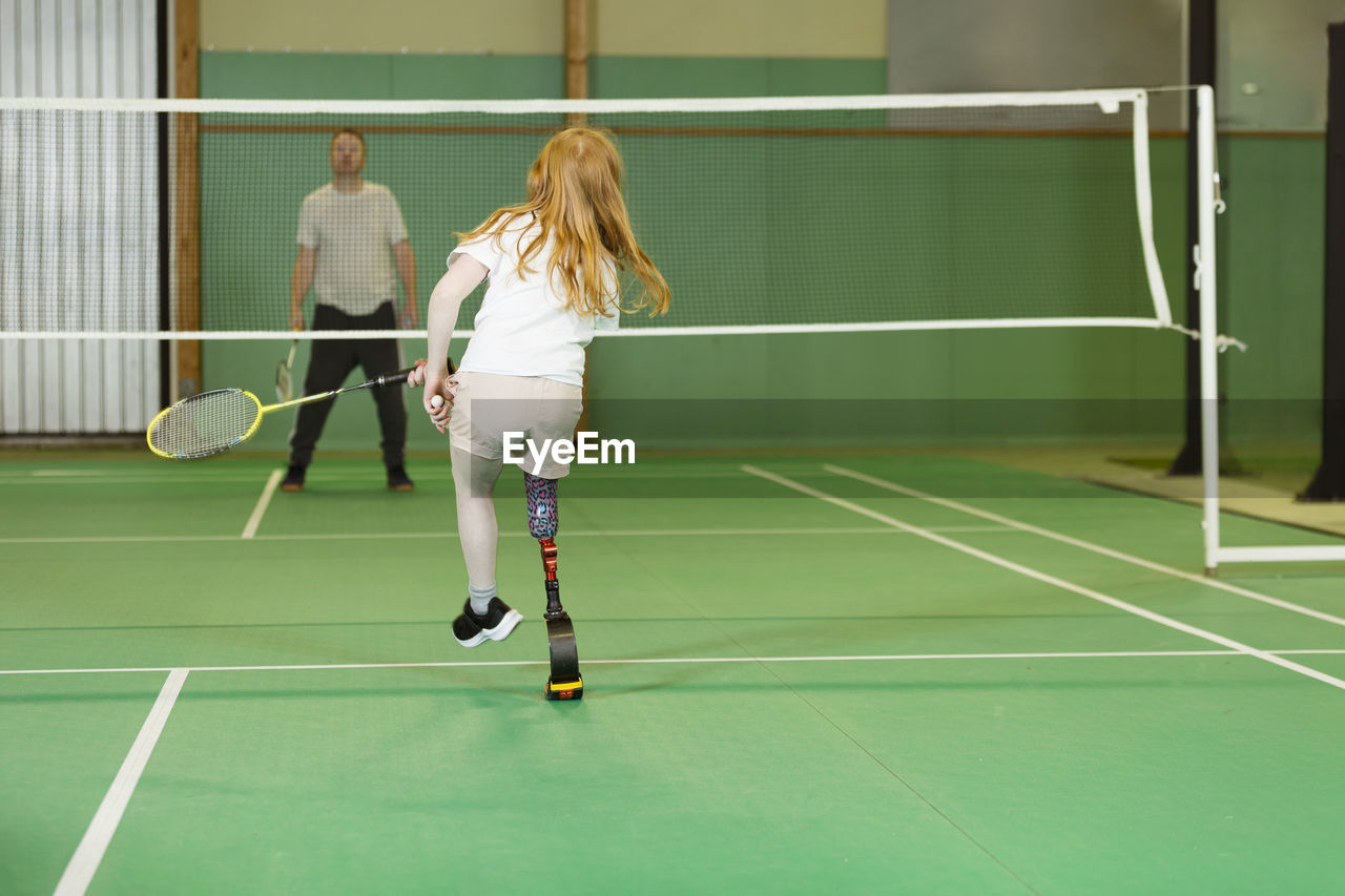 Girl with artificial leg playing badminton