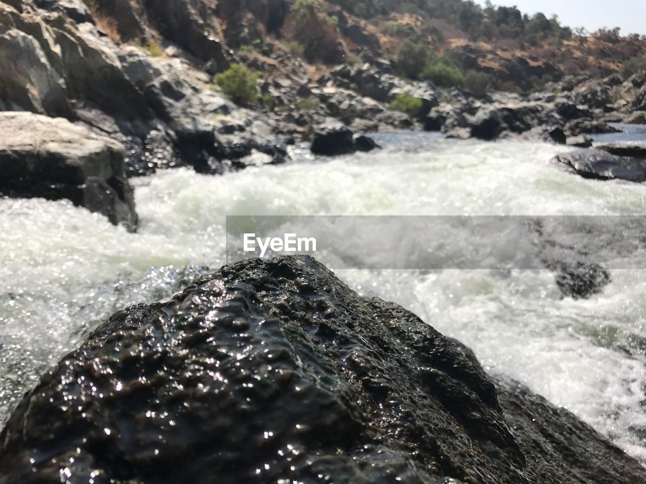 CLOSE-UP OF WAVE SPLASHING ON ROCK