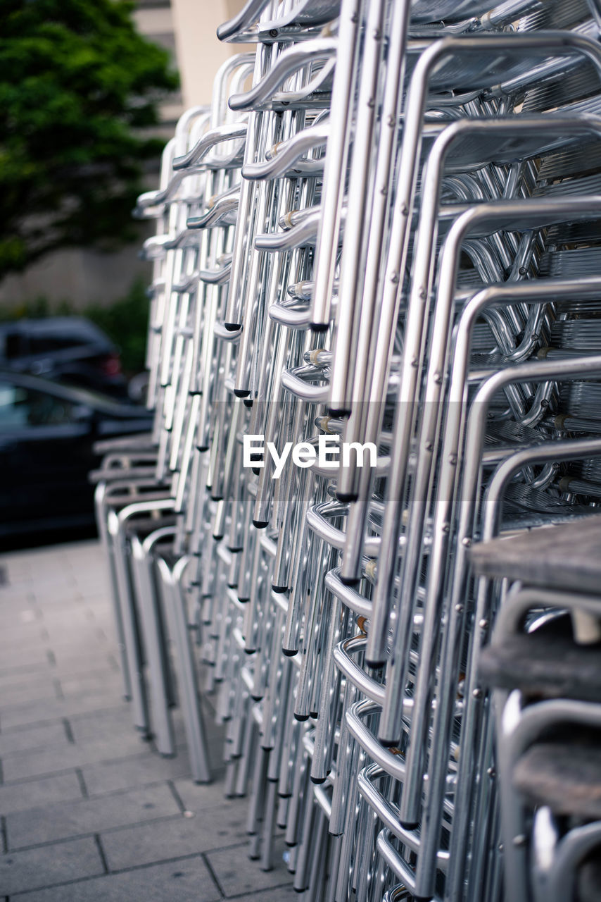 Stack of chairs on footpath