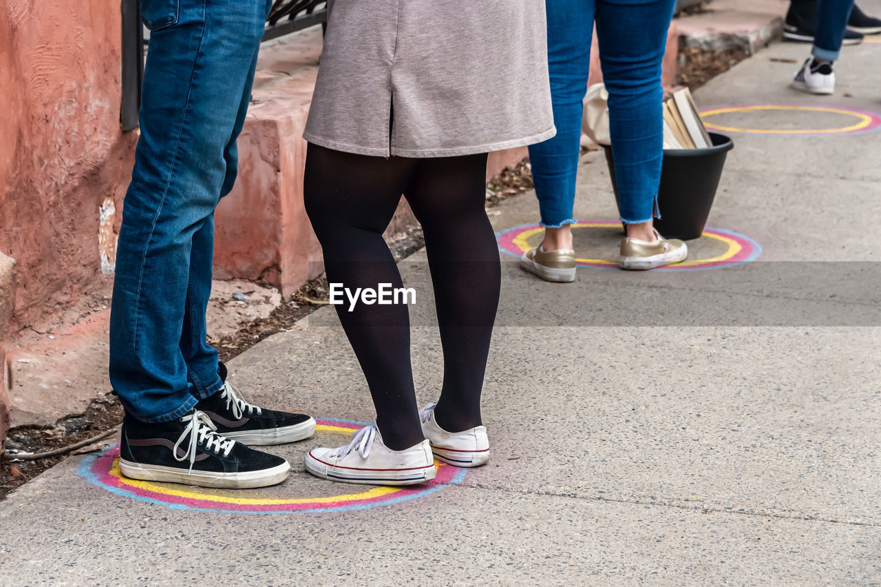 Low section of people standing on street