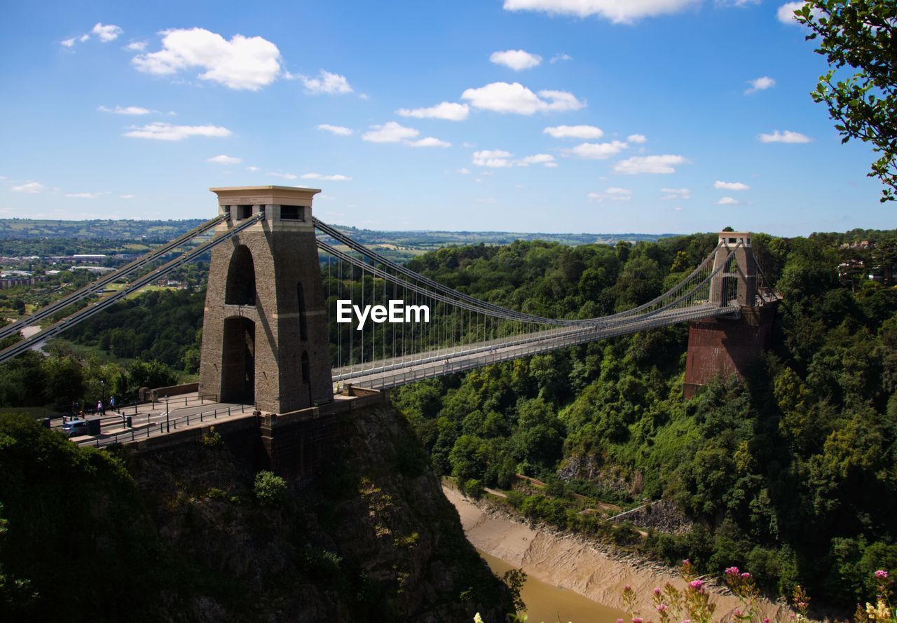 Bridge over mountain against sky