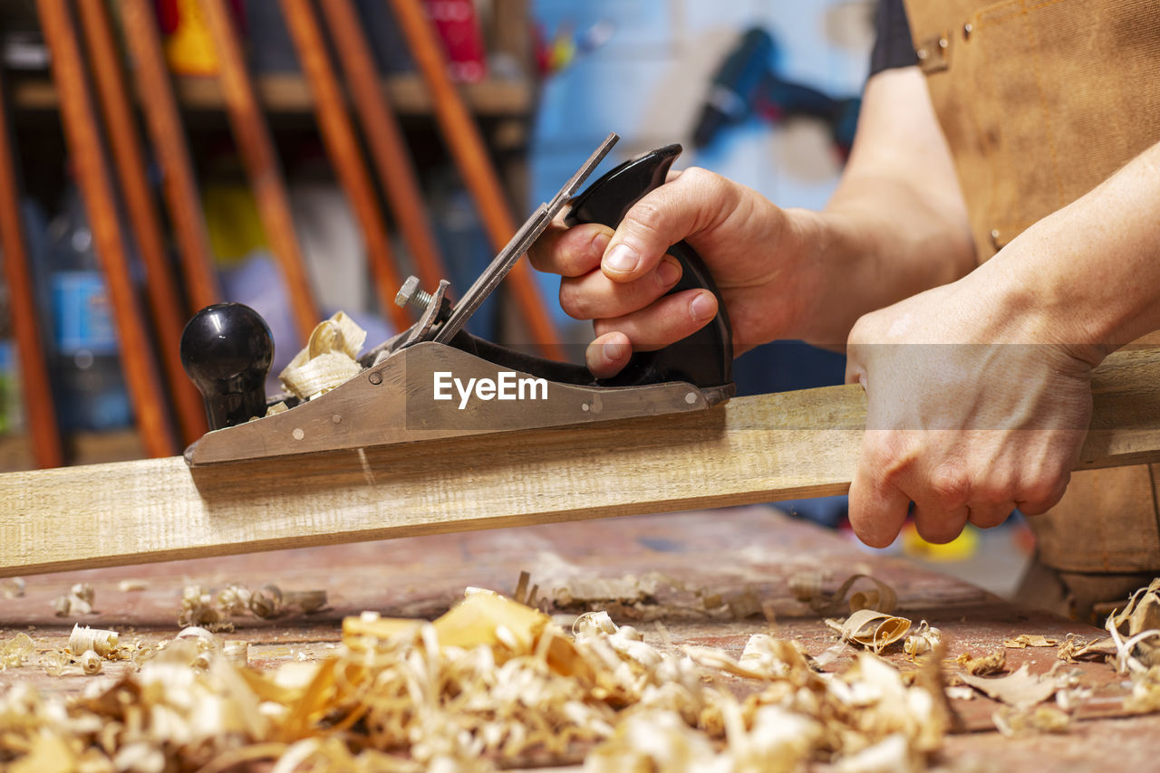 cropped image of man working on wood