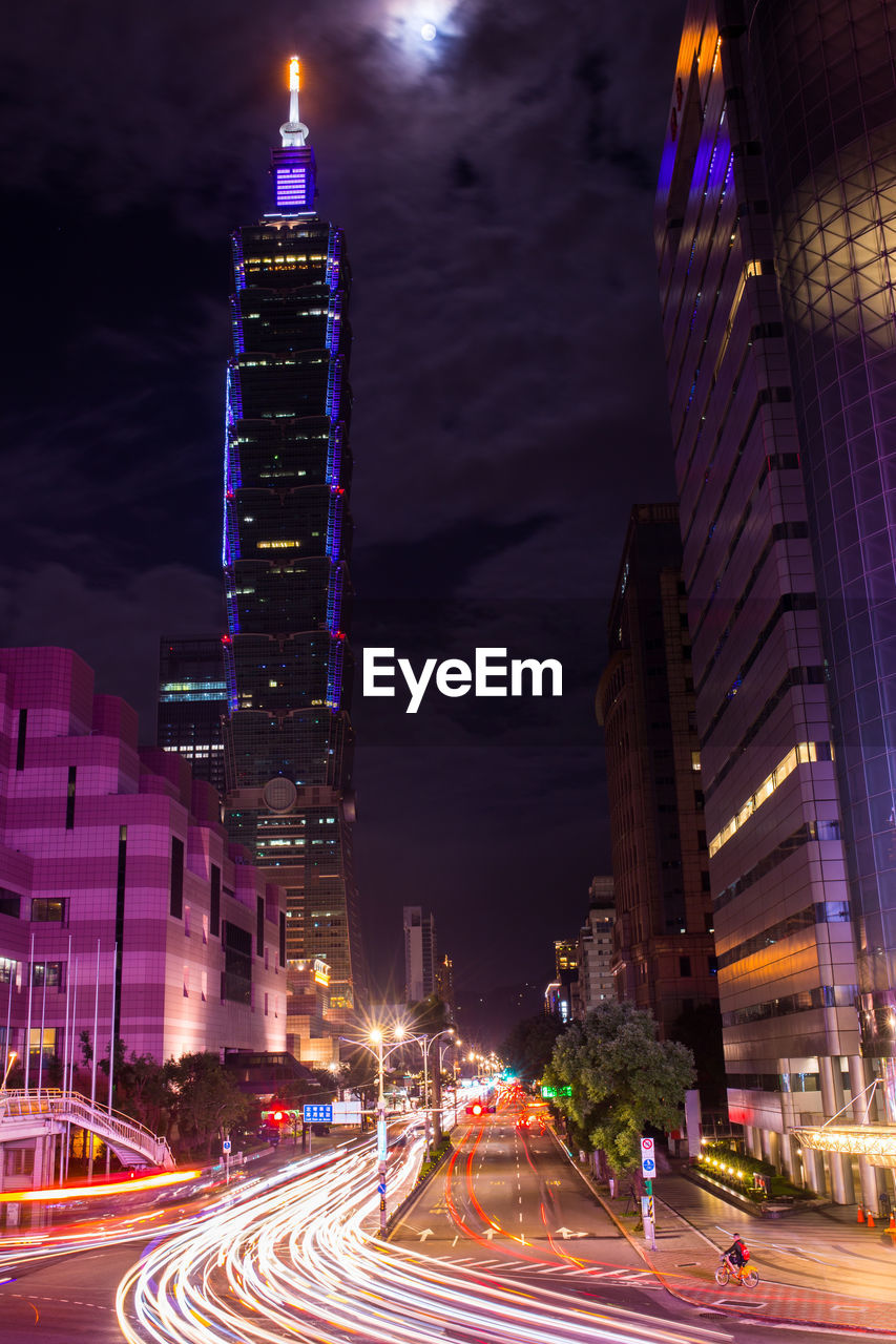 Illuminated city street and buildings at night