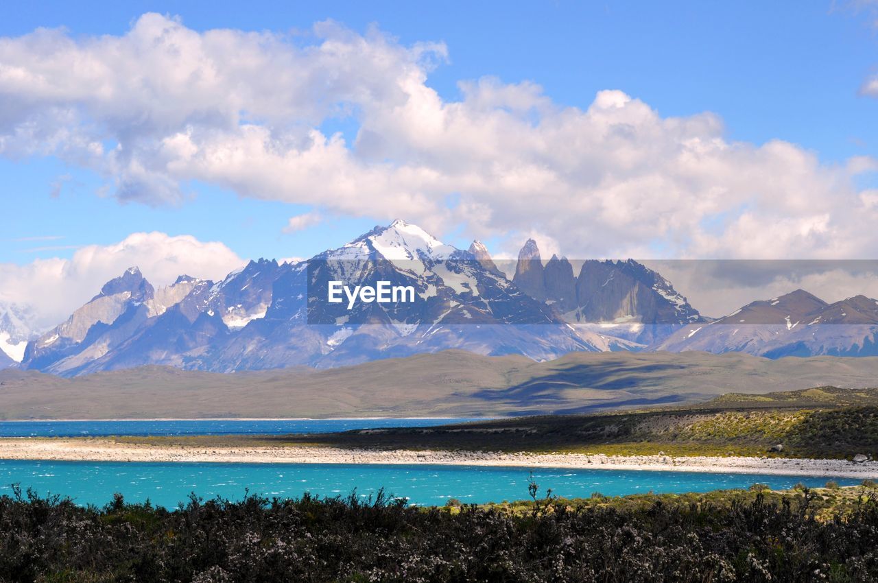 Scenic view of lake against cloudy sky