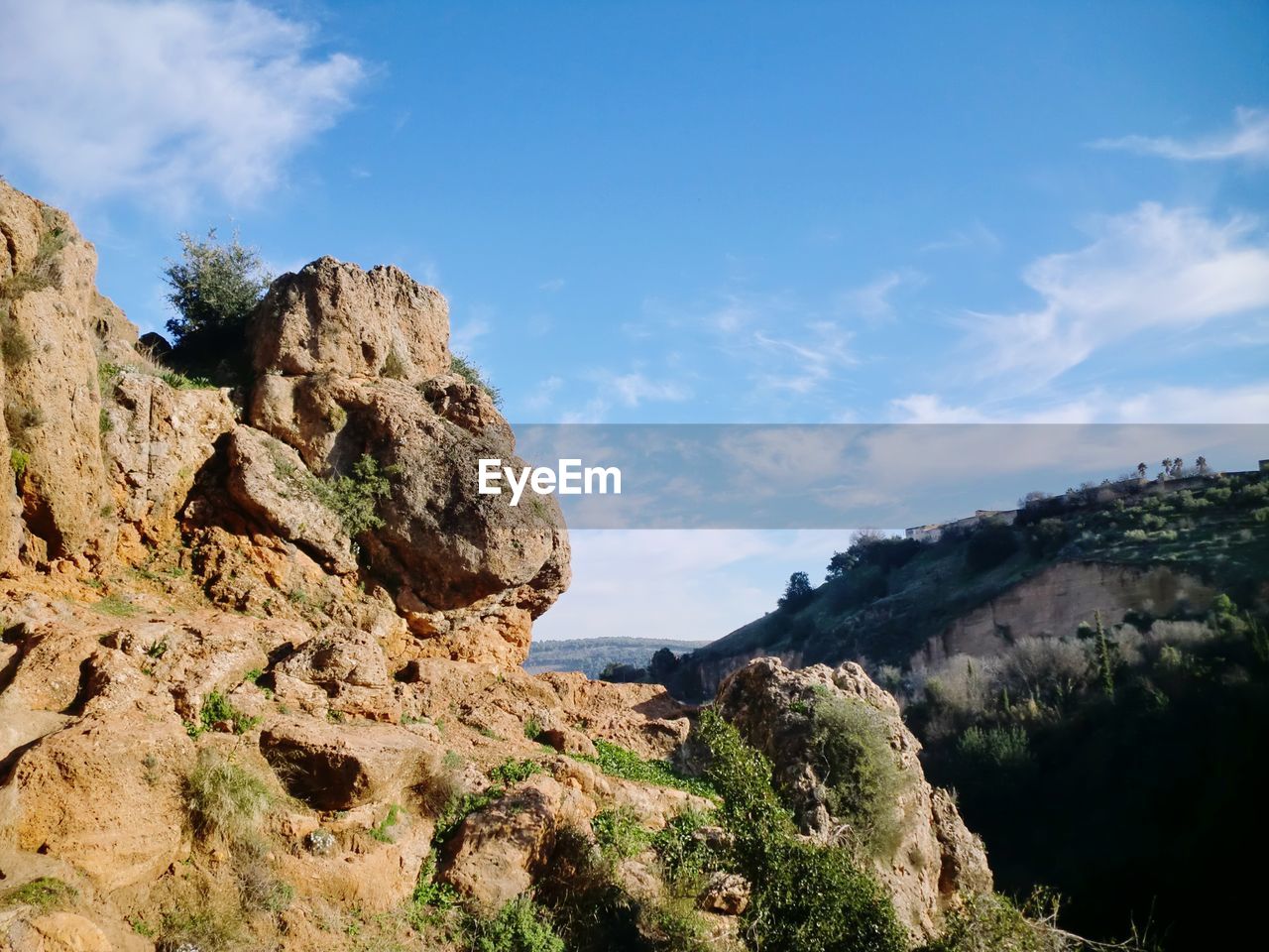 Rock formations on landscape against sky