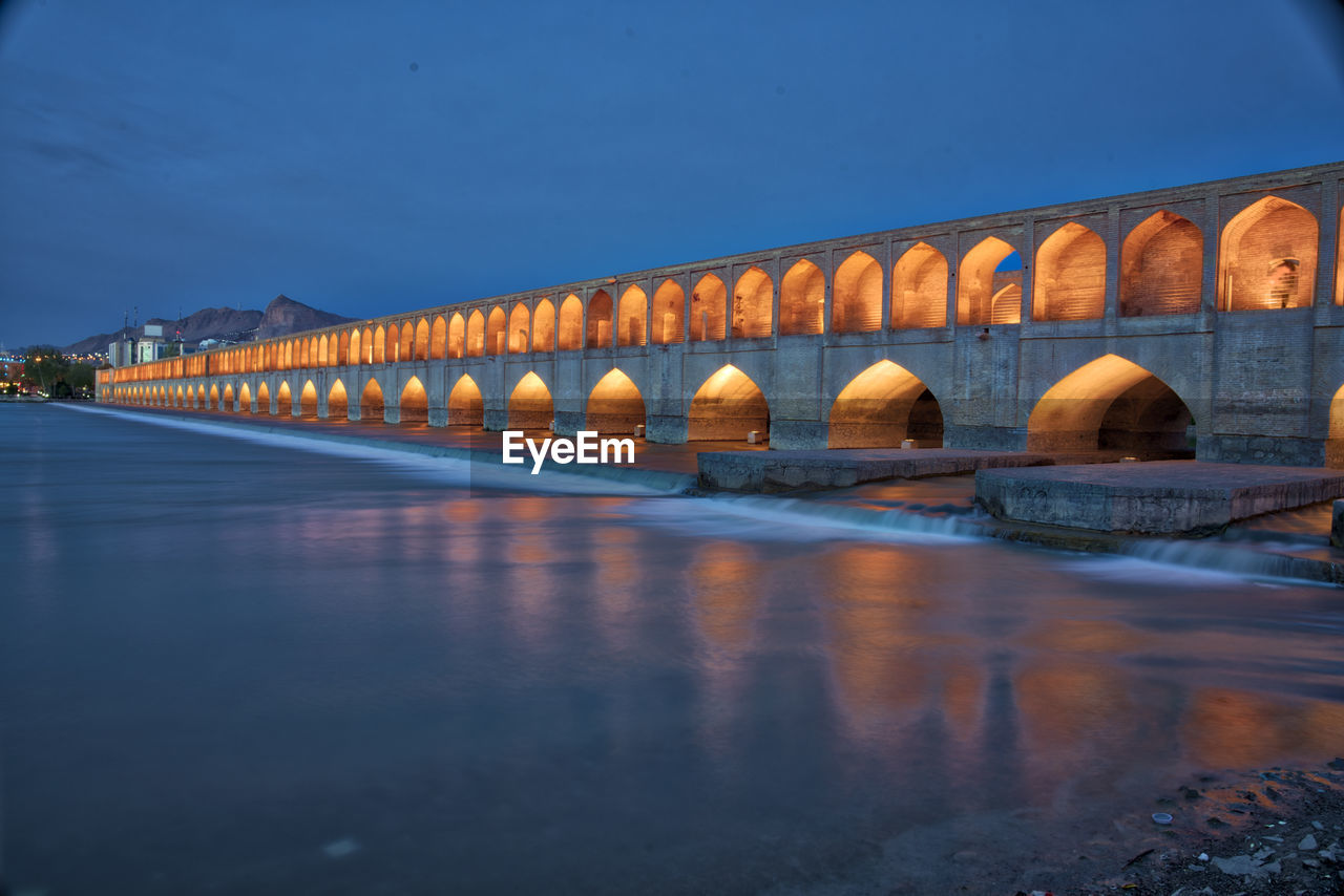 ARCH BRIDGE OVER RIVER AGAINST SKY