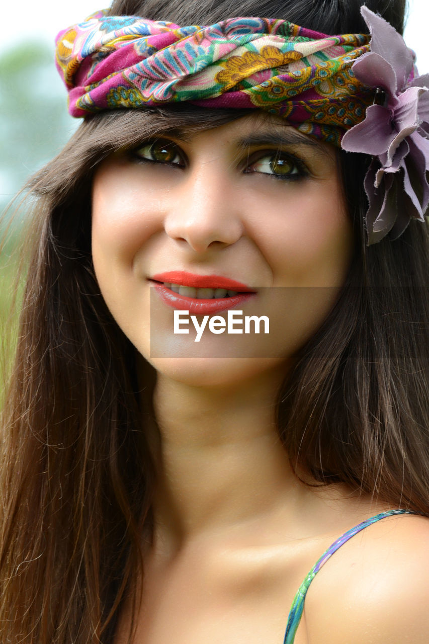 Close-up of smiling woman looking away while wearing headband