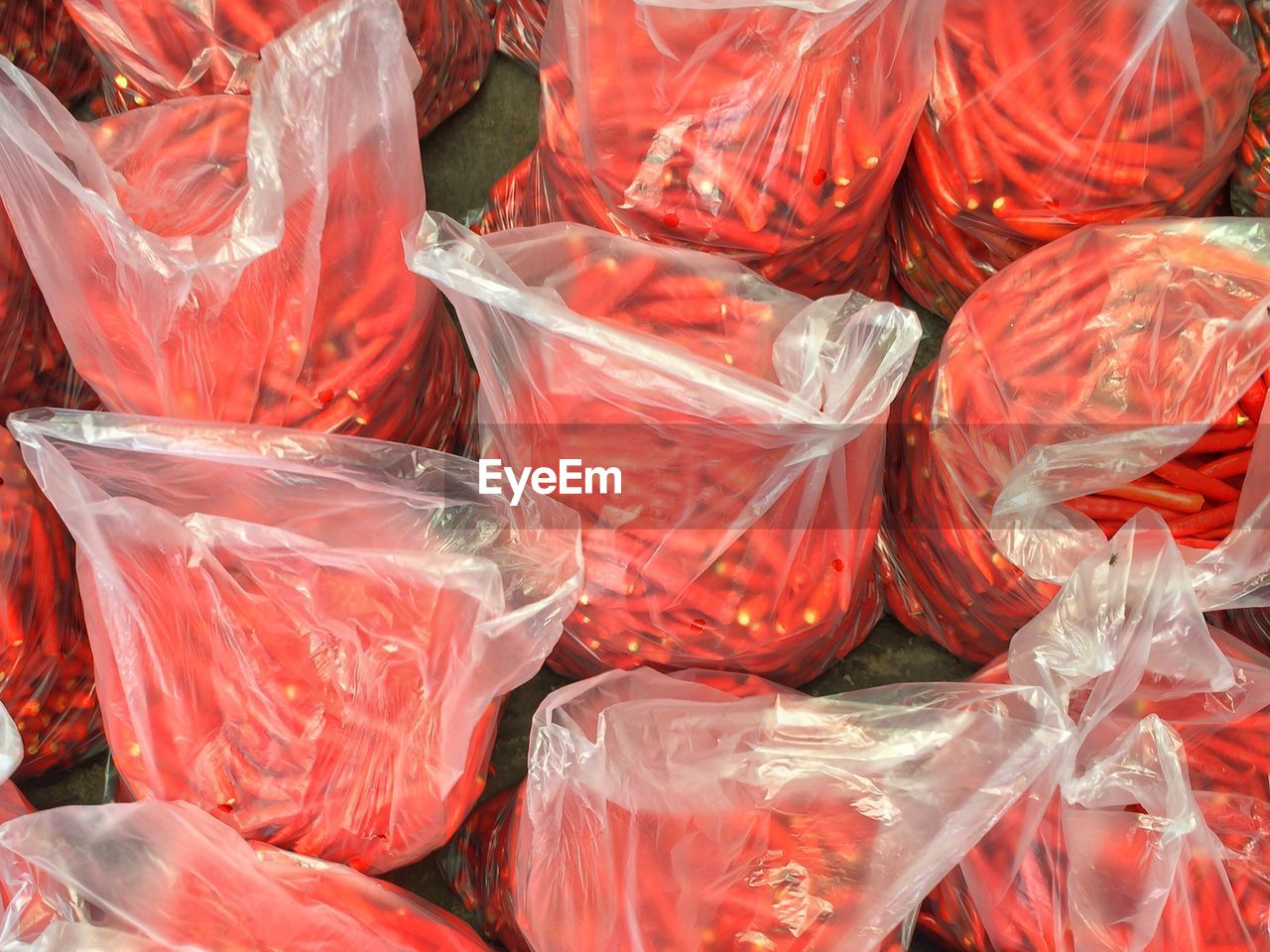 High angle view of red chili peppers in plastic bag