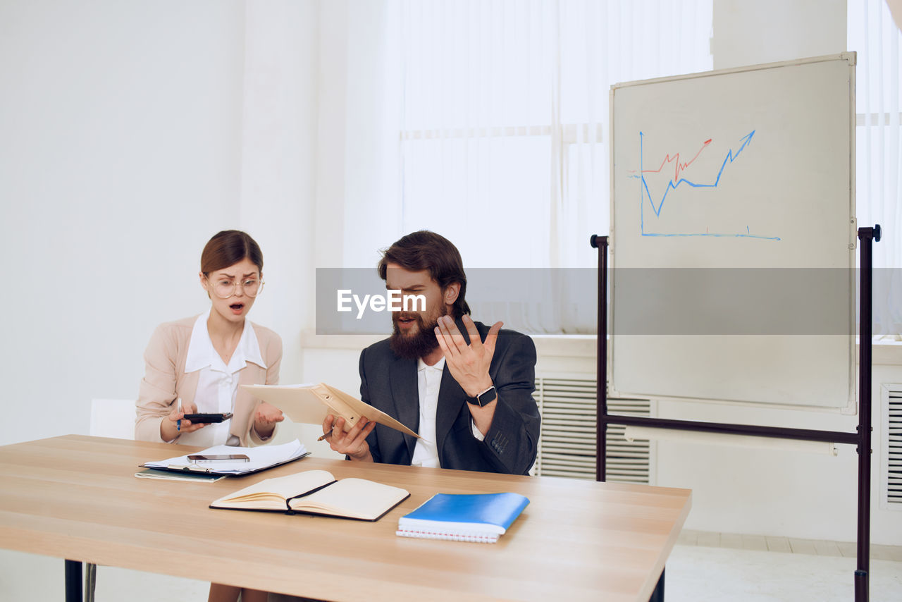 Worried business people sitting at office