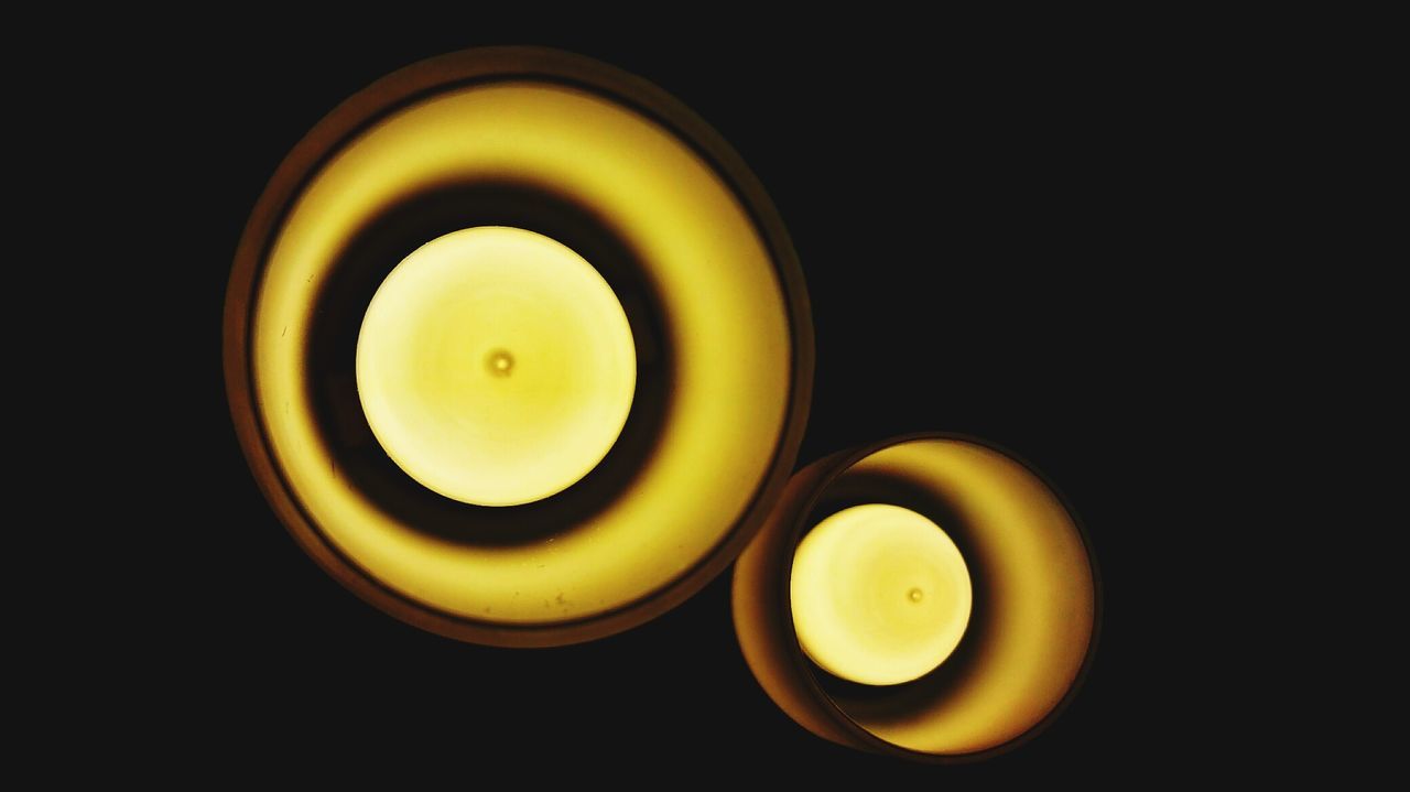Low angle view of illuminated lighting equipment in darkroom