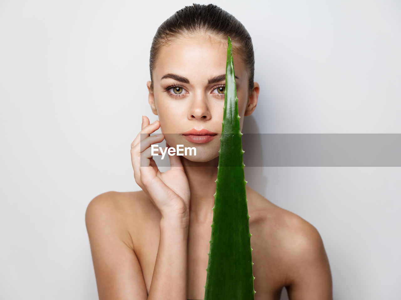 Portrait of young woman against white background