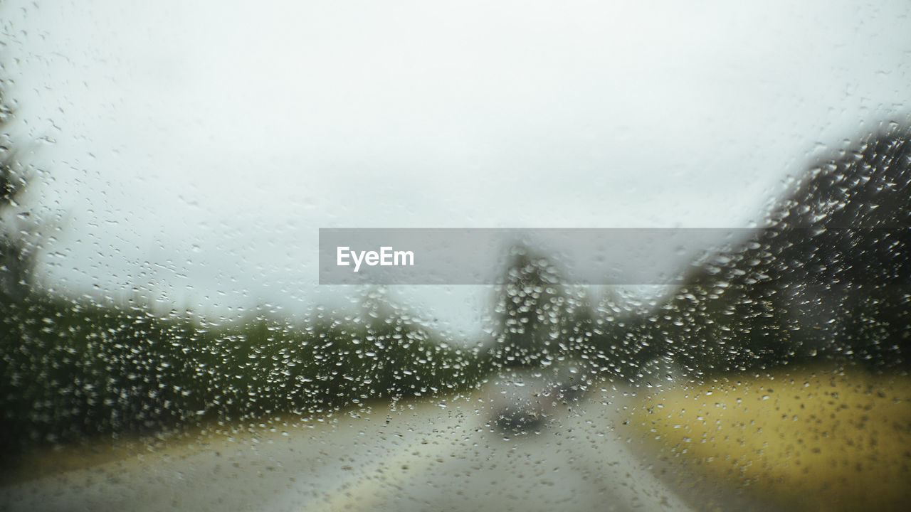 WATER DROPS ON WINDOW AGAINST SKY